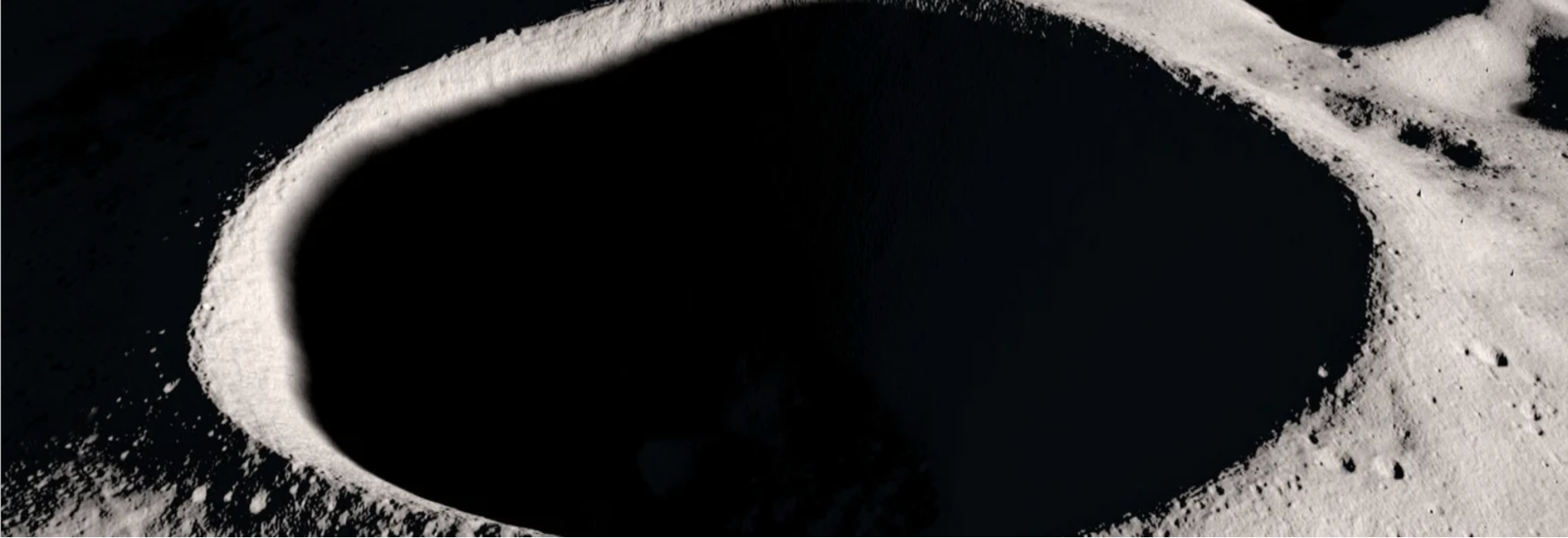 Image of a lunar crater with a dark permanently shadowed region used in teaching about lunar resource mapping